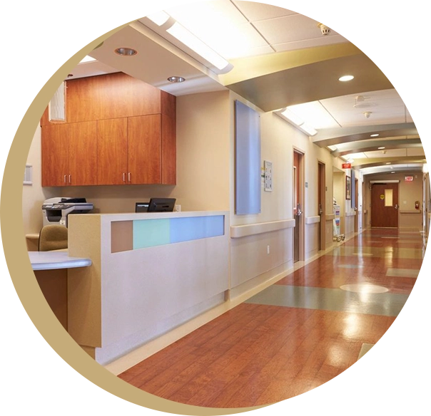 A view of a hospital hallway with wooden floors.