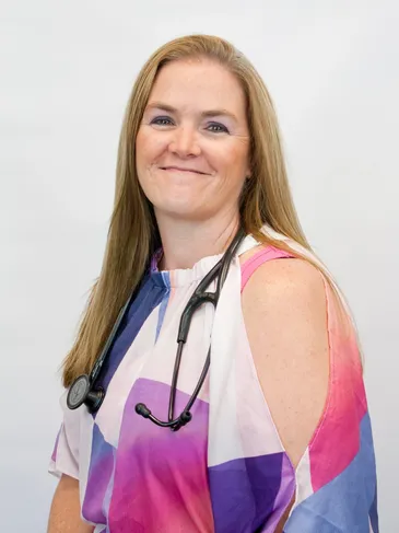 A woman with a stethoscope around her neck.